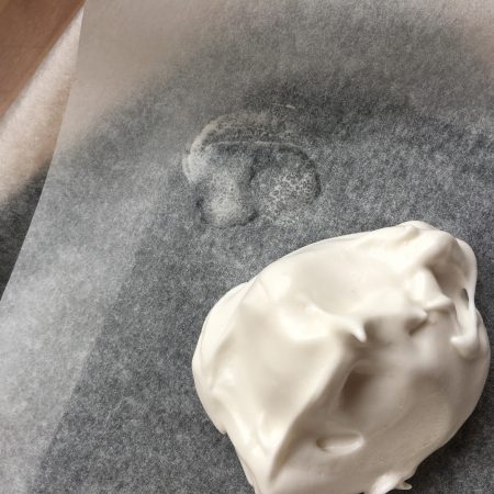 Stick down baking paper with meringue mix